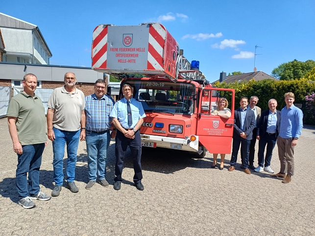Drehleiterfahrzeug aus Melle für die Ukraine Fahrzeugübergabe im Sonnenschein mit (von links) Andreas Hafer, Alfred Reehuis, Bernd Gieshoidt, Achim Schlörmann, Jutta Dettmann, Konrad Schönberg, Dr. Robert Schönberg, Andreas Dreier und Roland Schönberg.